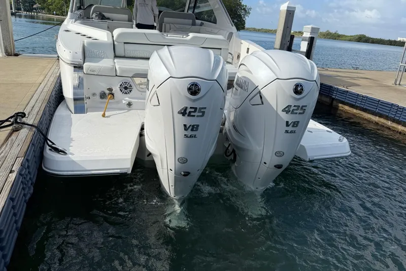 Slide: The Image of 2023 Regal LX36 boat with twin Yamaha 425 V8 engines docked at marina. - 5