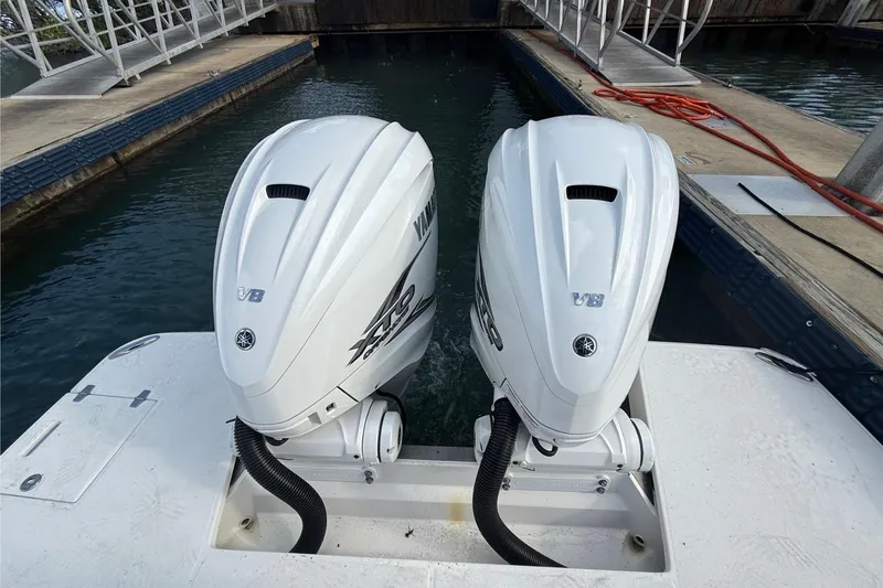 Slide: The Image of Twin Yamaha V8 outboard engines on a 2023 Regal LX36 boat at a dock. - 6
