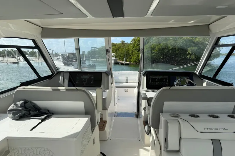 Slide: The Image of Interior view of 2023 Regal LX36 boat cockpit with modern controls and seating. - 9
