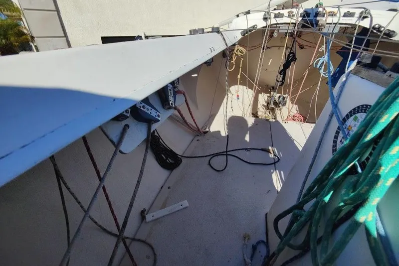 Slide: The Image of Interior view of a 1982 Ontario Etchells sailboat cockpit with ropes and equipment. - 11
