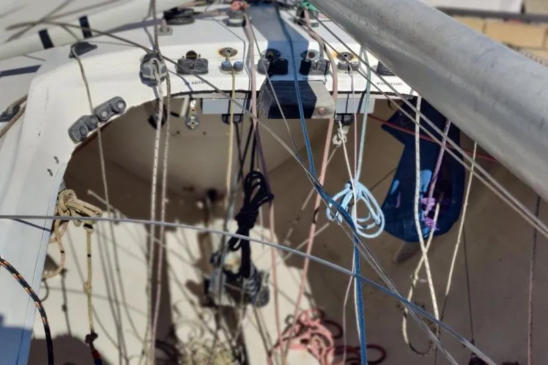 Slide: The Image of Cockpit view of a 1982 Ontario Etchells sailboat with rigging and ropes. - 12