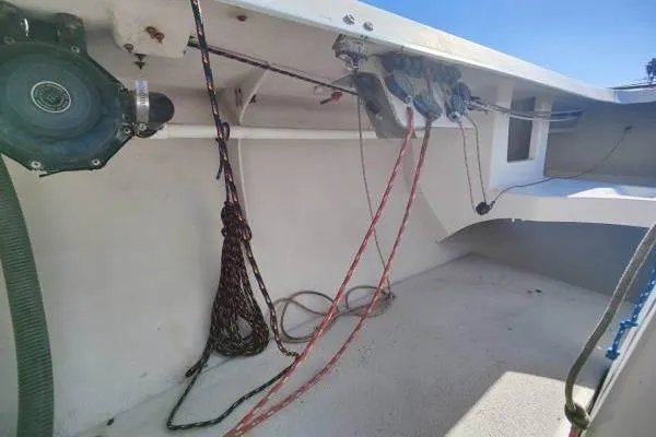 Slide: The Image of Interior view of a 1982 Ontario Yachts Etchells sailboat, showcasing rigging and ropes. - 13