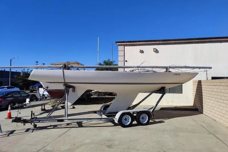 Slide: The Image of 1982 Ontario Etchells sailboat on trailer, parked outdoors under clear blue sky. - 2