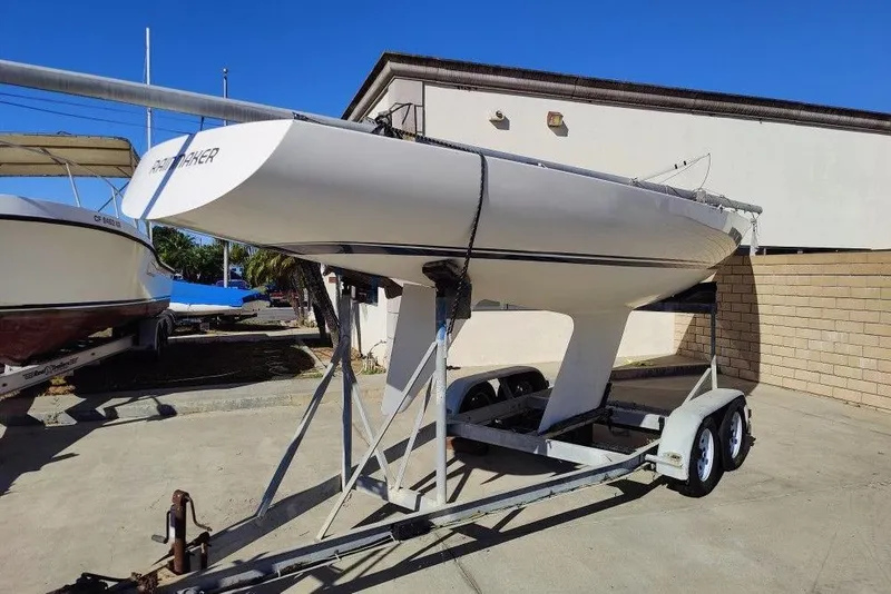 Slide: The Image of 1982 Ontario Etchells sailboat on trailer, parked outdoors under clear blue sky. - 5