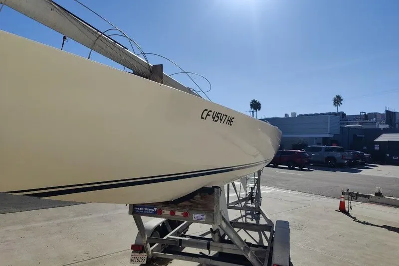 Slide: The Image of 1982 Ontario Etchells sailboat on trailer under clear blue sky. - 7