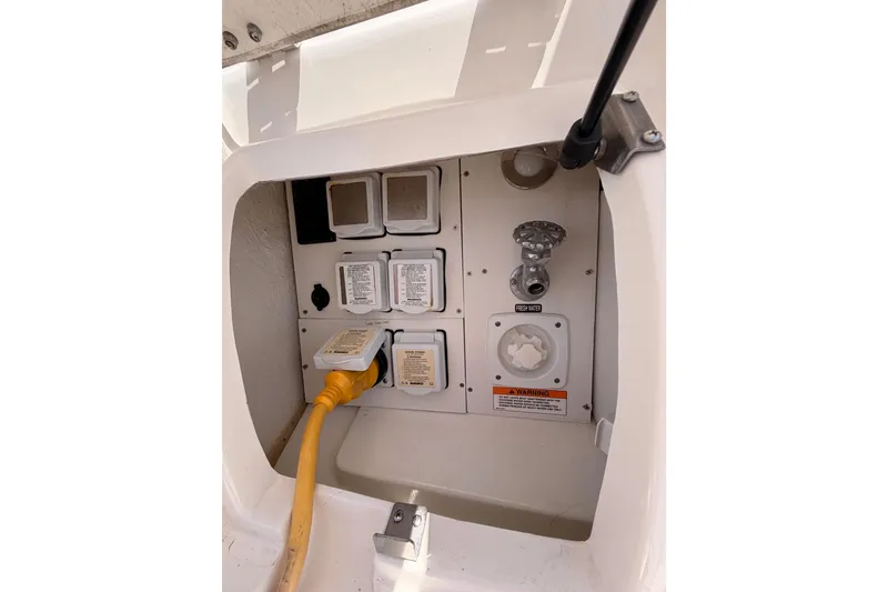 Slide: The Image of Electrical and water connections on a 2018 Sea Ray Sundancer 350 Coupe boat. - 10