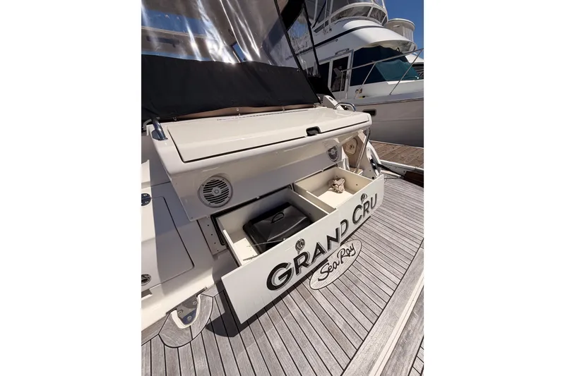 Slide: The Image of 2018 Sea Ray Sundancer 350 Coupe with open storage, docked at marina. - 11