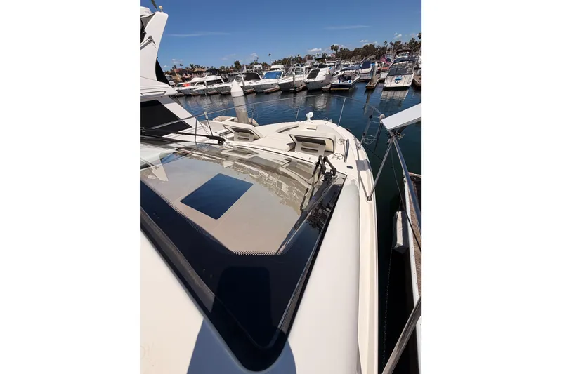 Slide: The Image of 2018 Sea Ray Sundancer 350 Coupe docked at marina, surrounded by boats. - 14