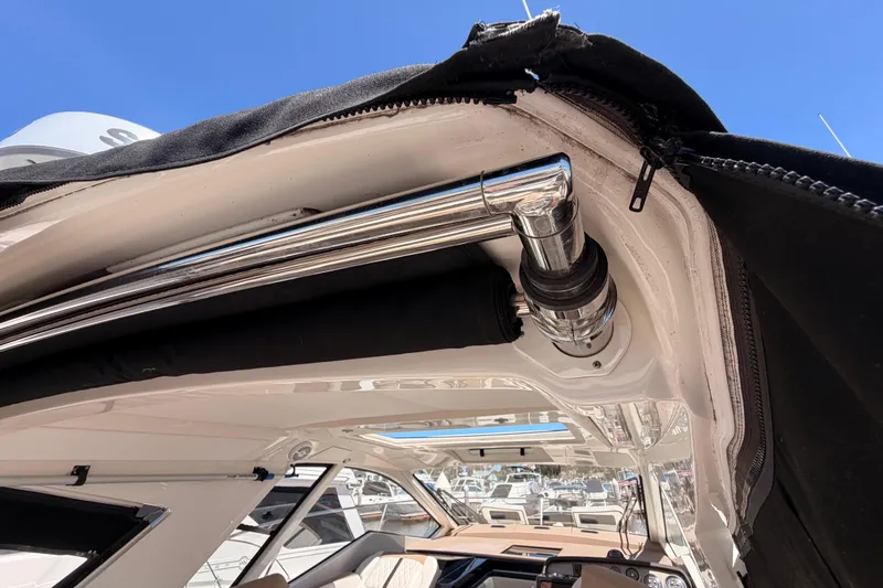 Slide: The Image of 2018 Sea Ray Sundancer 350 Coupe interior with chrome detailing and open sunroof. - 18