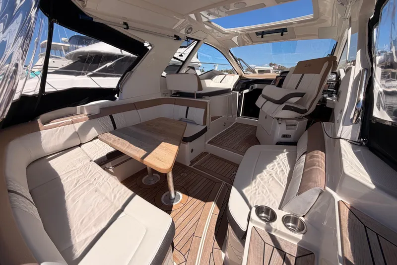Slide: The Image of Interior of 2018 Sea Ray Sundancer 350 Coupe with luxurious seating and wooden accents. - 19