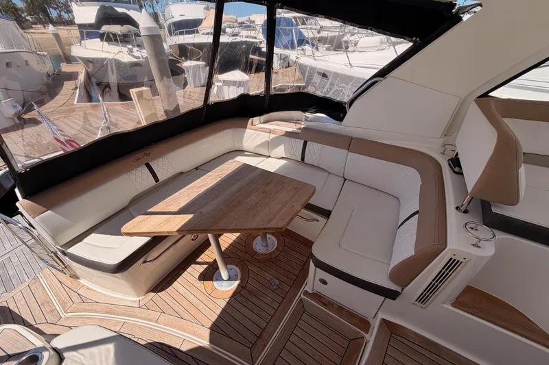 Slide: The Image of Luxurious 2018 Sea Ray Sundancer 350 Coupe interior with elegant seating and wooden table. - 20
