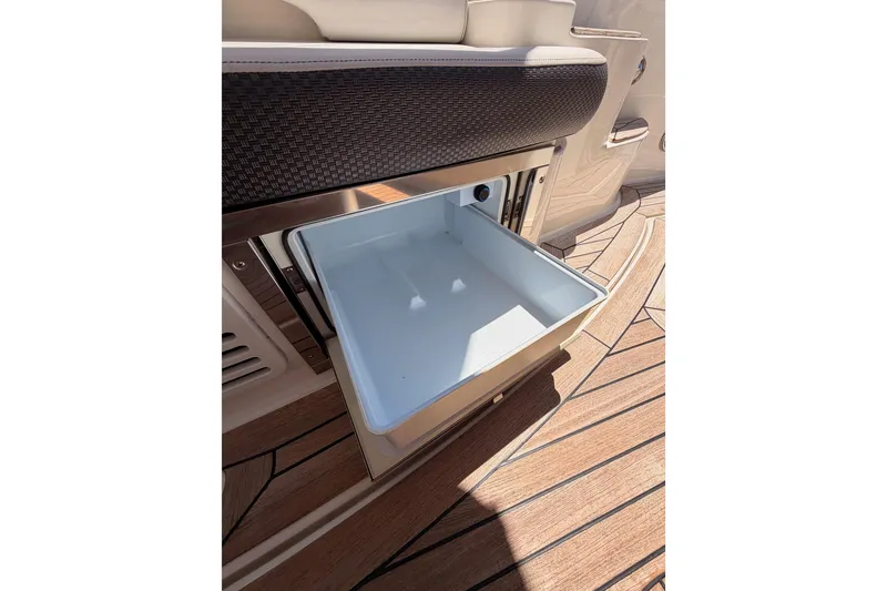 Slide: The Image of Open storage compartment on 2018 Sea Ray Sundancer 350 Coupe boat with wooden deck. - 26