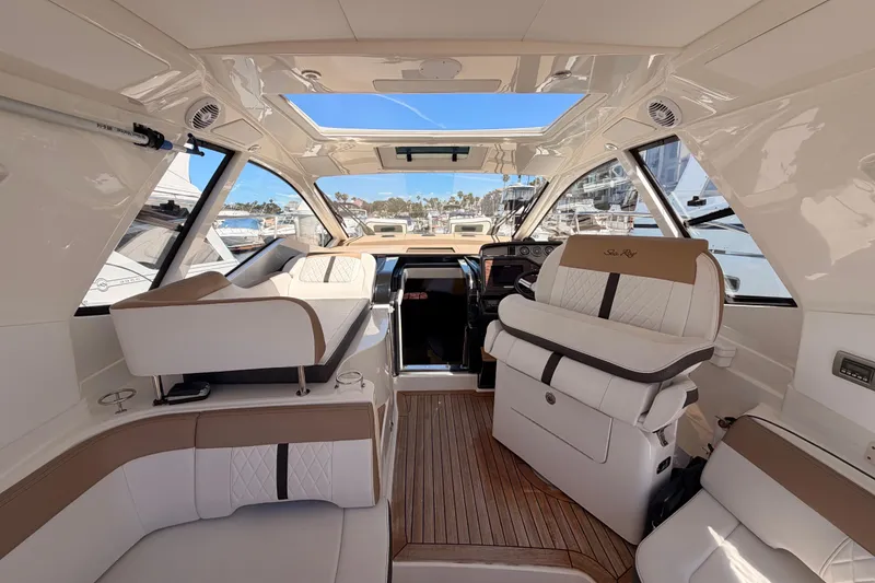 Slide: The Image of Interior of 2018 Sea Ray Sundancer 350 Coupe, featuring luxurious seating and helm. - 27