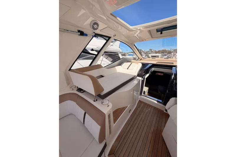 Slide: The Image of Interior of 2018 Sea Ray Sundancer 350 Coupe with sleek seating and wooden flooring. - 28