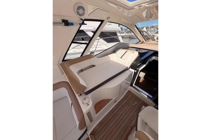 Slide: The Image of Interior of 2018 Sea Ray Sundancer 350 Coupe with luxurious seating and wood flooring. - 29