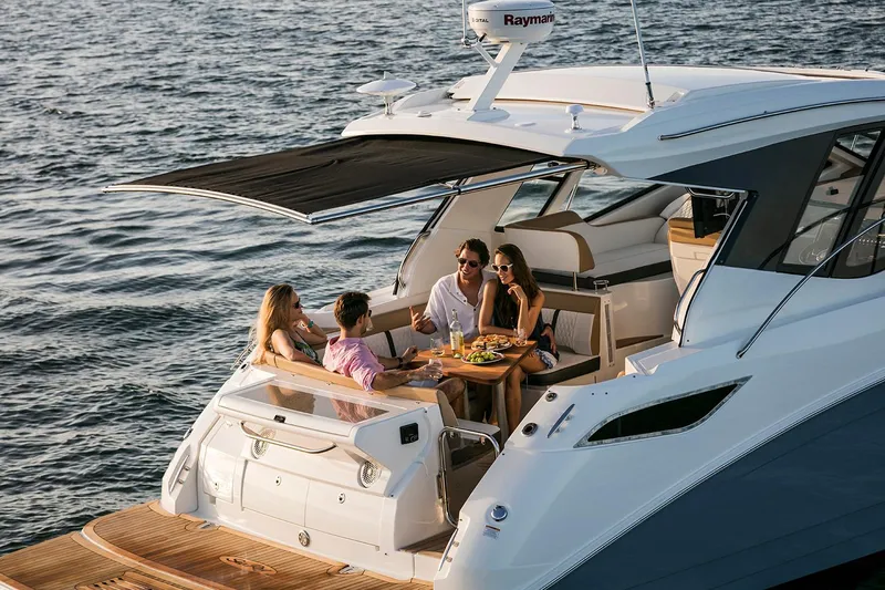 Slide: The Image of Manufacturer Provided Image: 2018 Sea Ray Sundancer 350 Coupe with people dining on deck. - 3