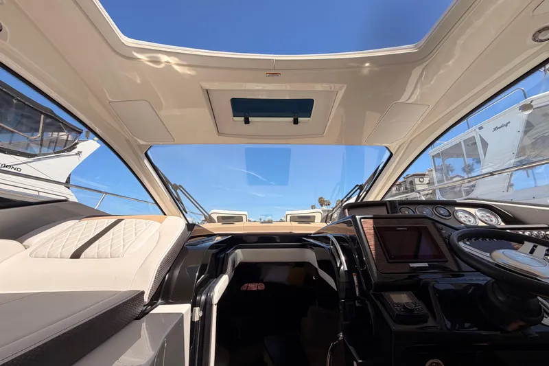 Slide: The Image of Interior view of 2018 Sea Ray Sundancer 350 Coupe cockpit with modern controls and seating. - 37