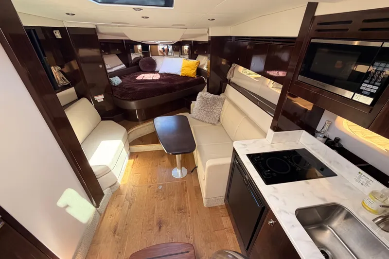 Slide: The Image of Interior of 2018 Sea Ray Sundancer 350 Coupe with modern kitchen and cozy seating area. - 40
