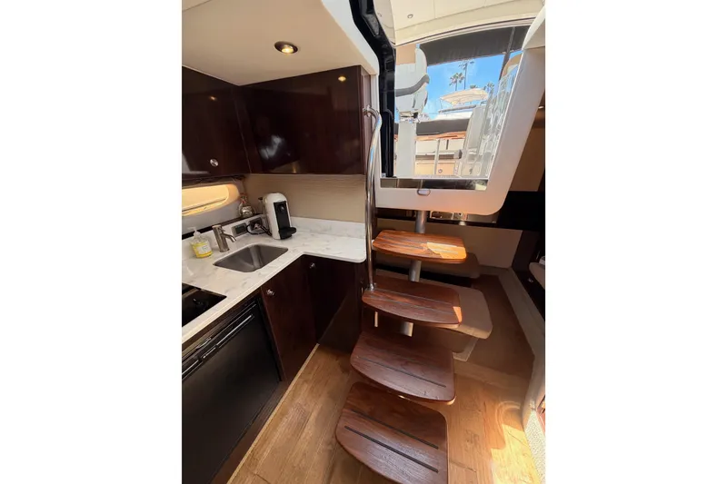 Slide: The Image of Interior of 2018 Sea Ray Sundancer 350 Coupe with modern kitchen and wooden stairs. - 46