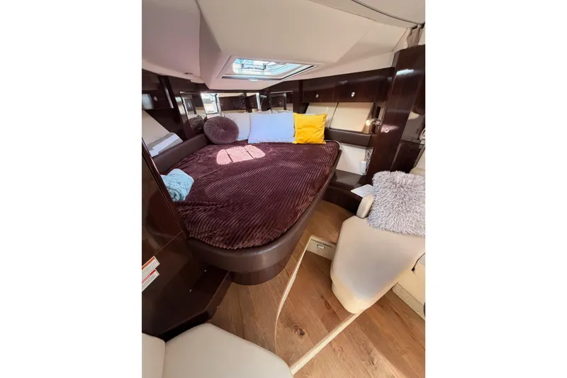 Slide: The Image of Luxurious interior cabin of 2018 Sea Ray Sundancer 350 Coupe with plush bedding. - 51
