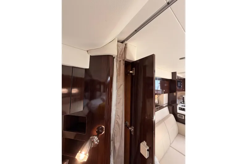Slide: The Image of Interior of 2018 Sea Ray Sundancer 350 Coupe with elegant wood finish and modern furnishings. - 52