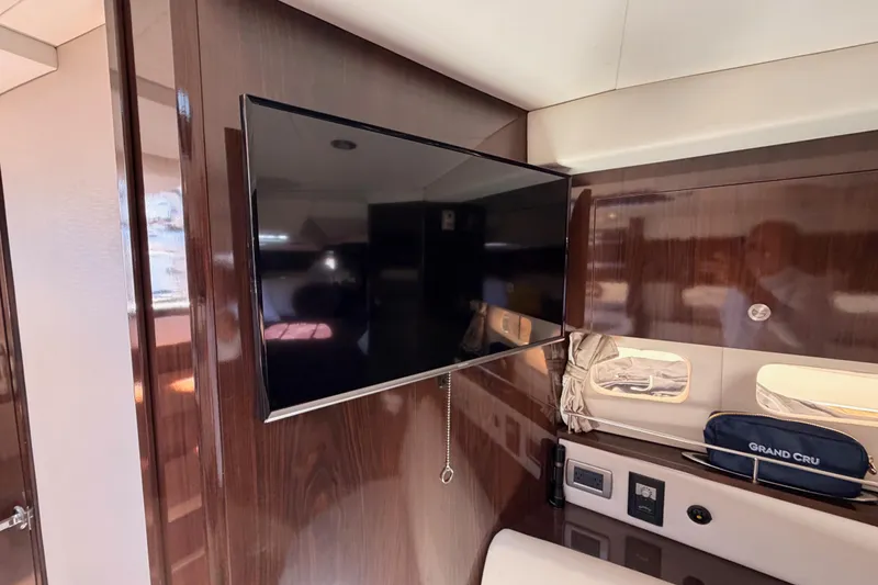Slide: The Image of Interior of 2018 Sea Ray Sundancer 350 Coupe with mounted TV and wooden paneling. - 54