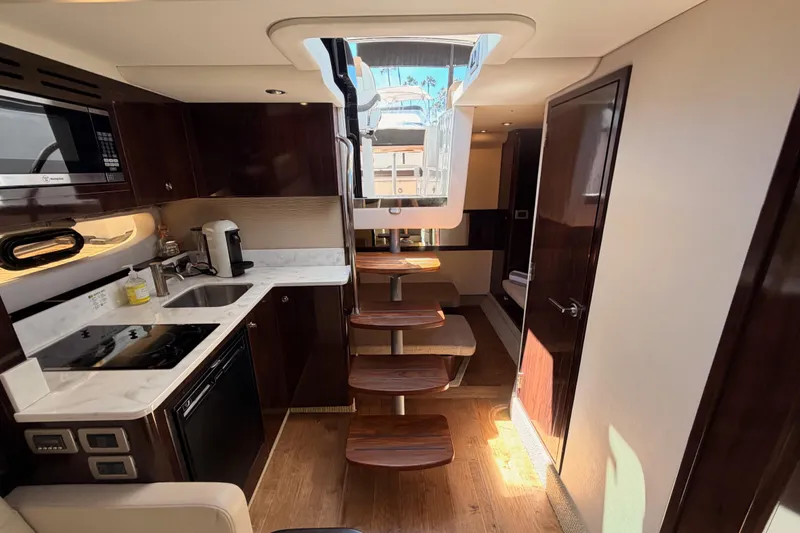 Slide: The Image of Luxurious interior of 2018 Sea Ray Sundancer 350 Coupe yacht with modern kitchen amenities. - 55