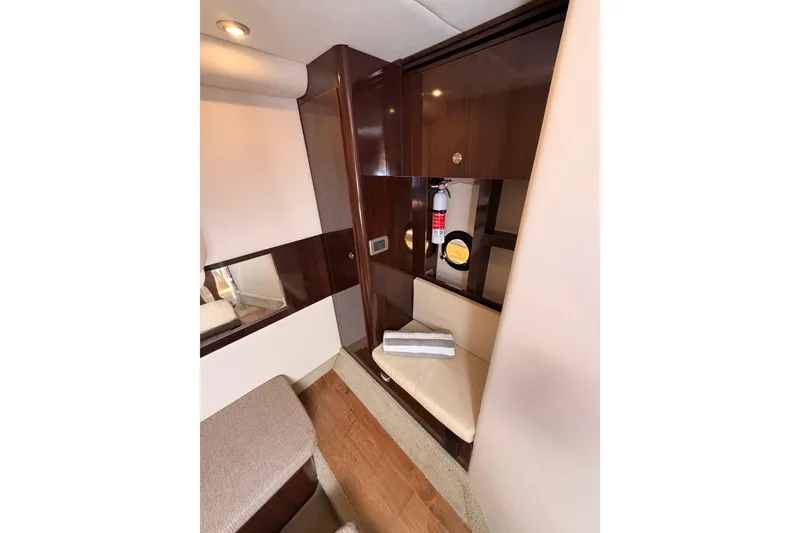 Slide: The Image of Interior of 2018 Sea Ray Sundancer 350 Coupe with wood paneling and seating area. - 59