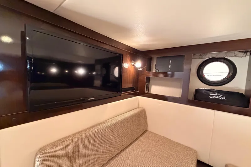 Slide: The Image of Interior of 2018 Sea Ray Sundancer 350 Coupe with TV and porthole window. - 63