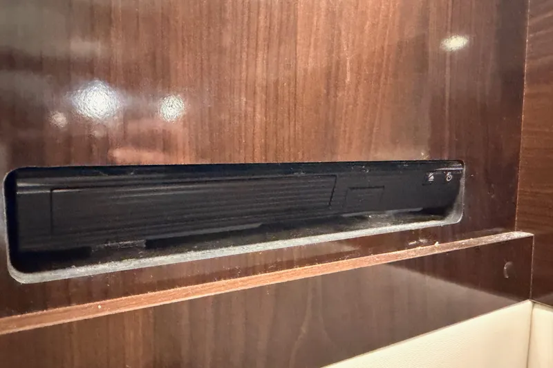 Slide: The Image of DVD player in 2018 Sea Ray Sundancer 350 Coupe's wooden interior panel. - 64