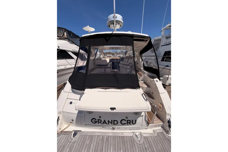 Slide: The Image of 2018 Sea Ray Sundancer 350 Coupe docked, rear view with black canopy. - 7