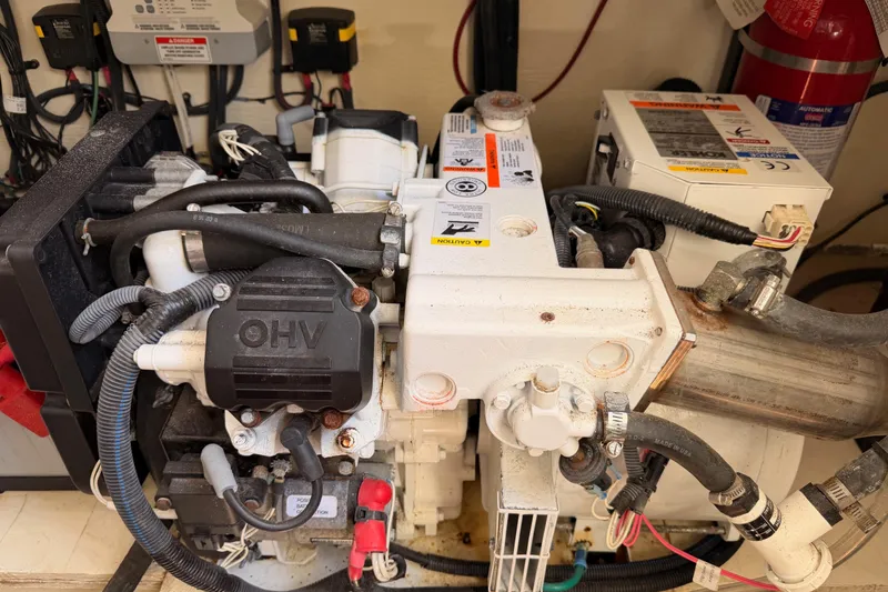 Slide: The Image of Engine compartment of a 2018 Sea Ray Sundancer 350 Coupe with visible wiring and components. - 71