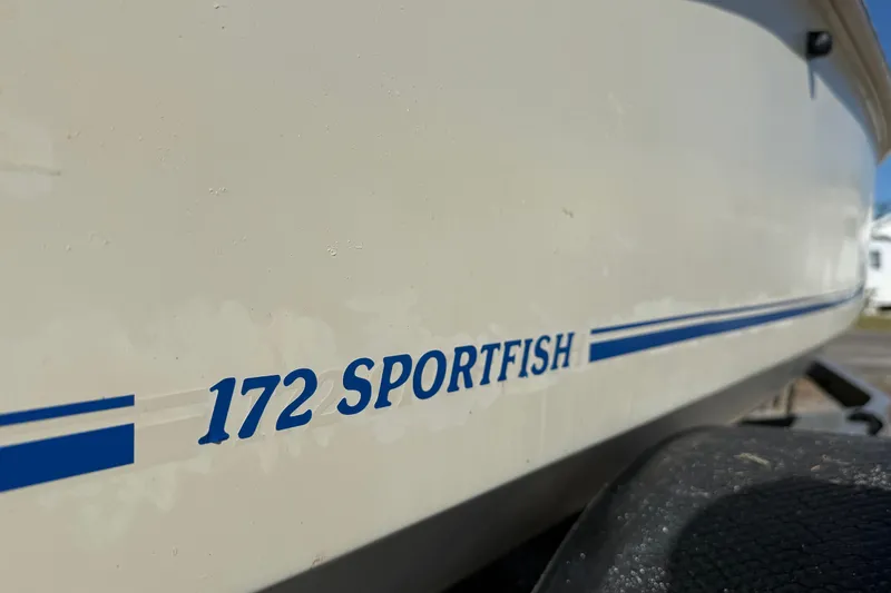 Slide: The Image of 1995 Scout 172 Sportfish boat with blue lettering on the hull. - 10