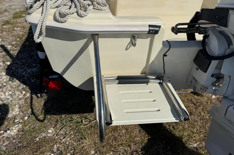Slide: The Image of 1995 Scout 172 Sportfish boat stern with swim platform and motor. - 11