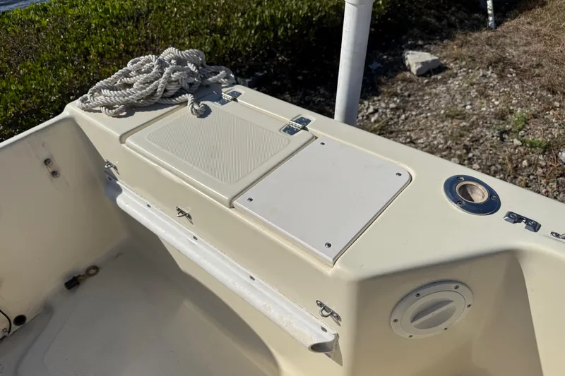 Slide: The Image of 1995 Scout 172 Sportfish boat interior with storage compartments and coiled rope. - 16