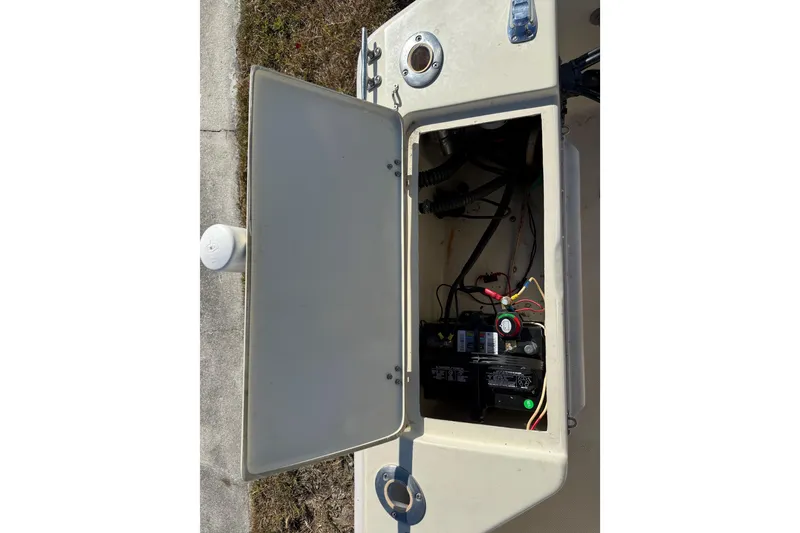 Slide: The Image of Open hatch of 1995 Scout 172 Sportfish boat showing battery compartment and wiring. - 19