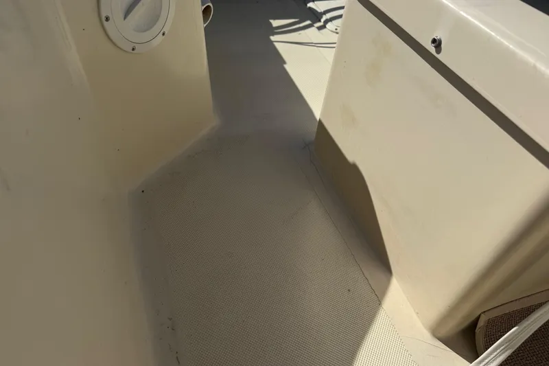 Slide: The Image of Interior view of a 1995 Scout 172 Sportfish boat, showing deck and storage compartment. - 21