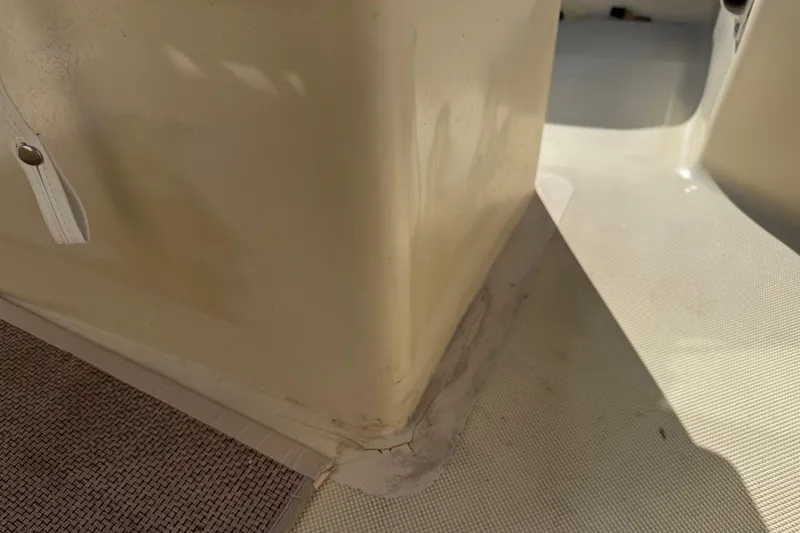 Slide: The Image of Close-up of a 1995 Scout 172 Sportfish boat interior, showing corner details and flooring. - 24