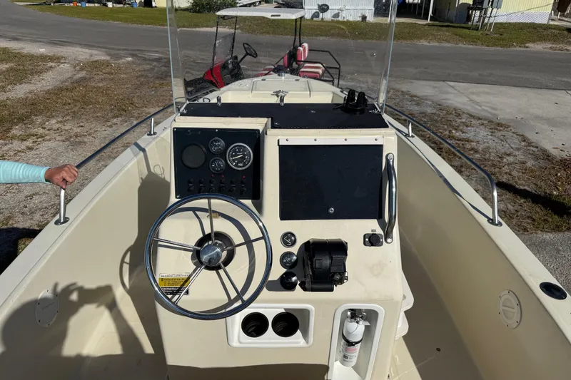 Slide: The Image of 1995 Scout 172 Sportfish boat dashboard with steering wheel and gauges. - 25