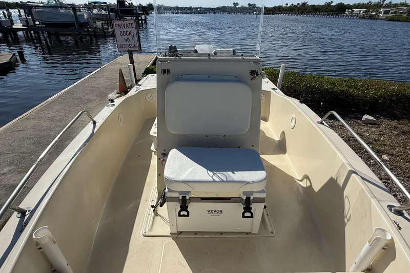 Slide: The Image of 1995 Scout 172 Sportfish boat docked by a private pier, featuring a Vevor cooler seat. - 30