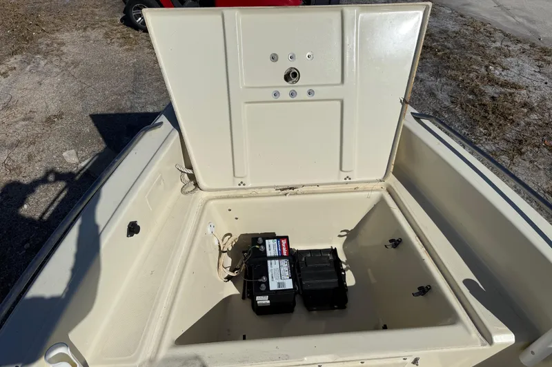Slide: The Image of Open storage compartment of 1995 Scout 172 Sportfish boat with battery inside. - 35