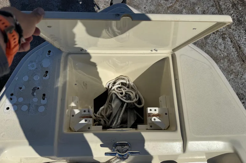 Slide: The Image of Open storage compartment on a 1995 Scout 172 Sportfish boat, containing rope. - 38