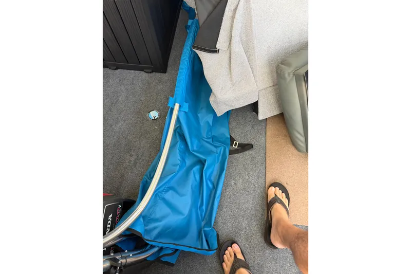 Slide: The Image of Blue tarp and equipment on a 1995 Scout 172 Sportfish boat deck. - 41