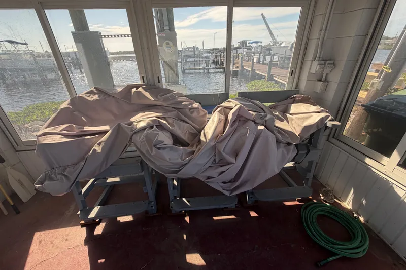 Slide: The Image of Covered 1995 Scout 172 Sportfish boat in a boathouse with waterfront view. - 42