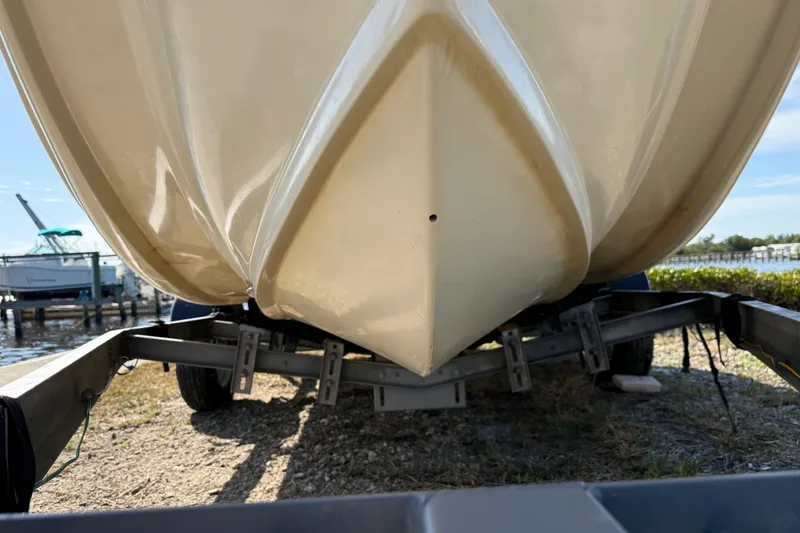 Slide: The Image of 1995 Scout 172 Sportfish boat on trailer, close-up of hull, sunny day. - 6