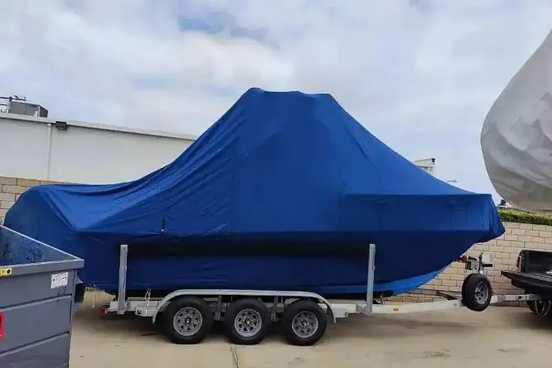 Slide: The Image of Covered 1978 SeaCraft SC 21 Open boat on trailer, wrapped in blue tarp. - 11