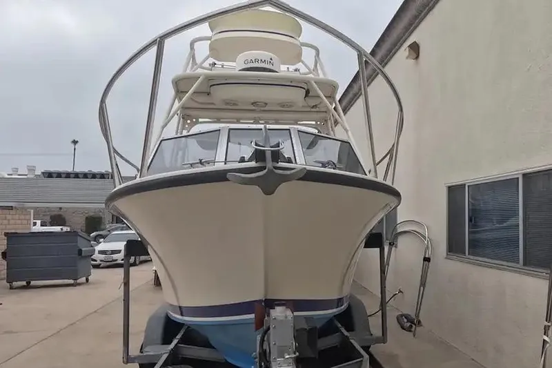 Slide: The Image of 1978 SeaCraft SC 21 Open boat on trailer, featuring Garmin equipment, parked beside a building. - 6