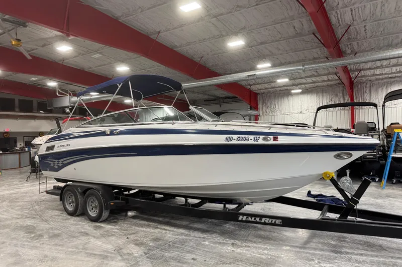 The Image of 2003 Crownline 270 BR boat on trailer in indoor storage facility. - 1