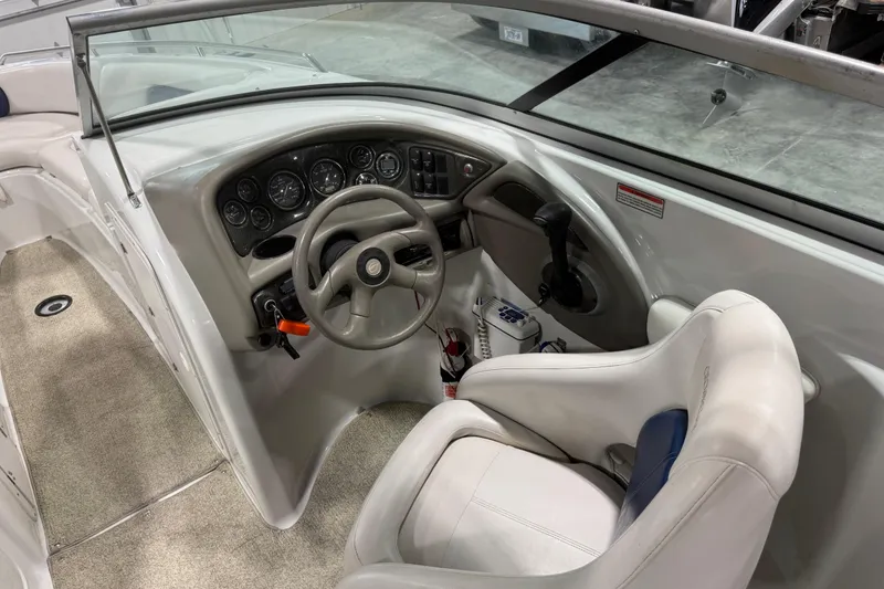 Slide: The Image of Interior view of a 2003 Crownline 270 BR boat cockpit with steering wheel and controls. - 7