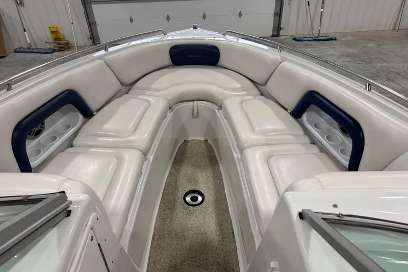 Slide: The Image of 2003 Crownline 270 BR boat interior with white seating and blue accents. - 9
